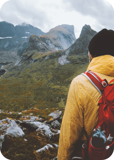 Man Exploring Sunset Mountains with Backpack