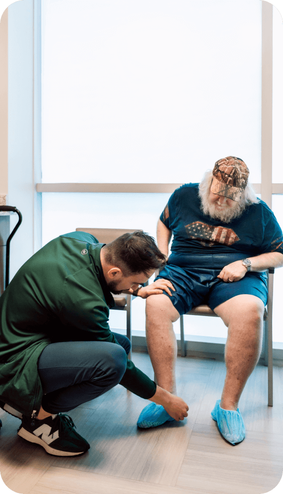 Doctor examining an elderly man's foot