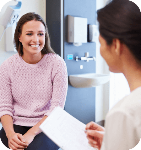 A female doctor discussing post-atherectomy recovery with a female patient.