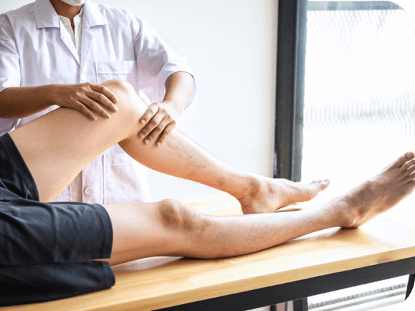 A healthcare provider's skilled hands gently palpate a patient's knee during a leg examination