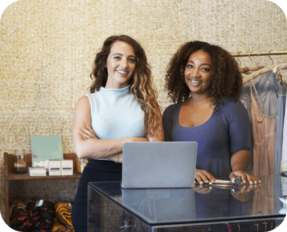 Two young women smiling and looking at the camera in a cheerful mood