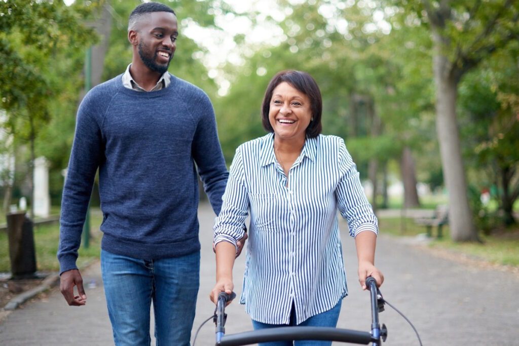 Elderly woman accompanied by a young black boy during a walk.