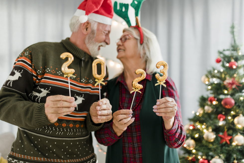 Senior couple holding numbers 2023 while celebrating New Year