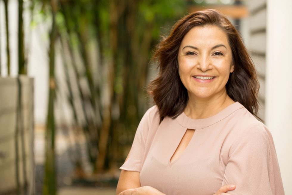 Portrait of a happy Hispnaic woman smiling.