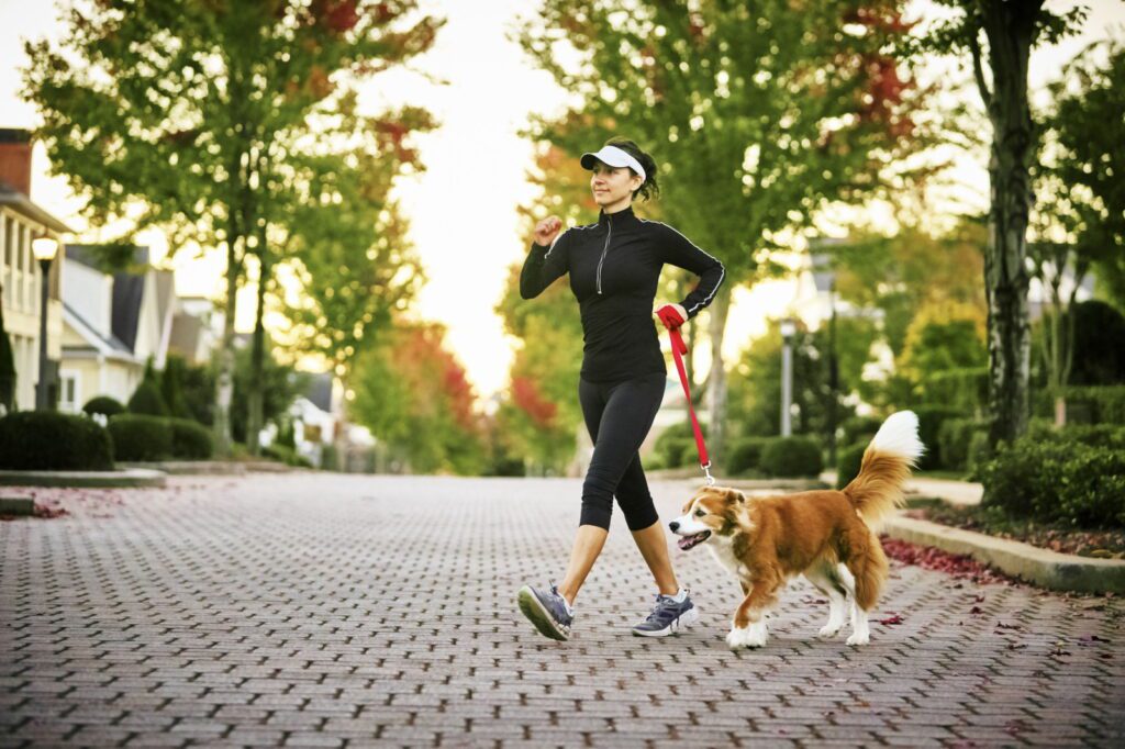 A young girl with leg circulation issues is walking with her dog