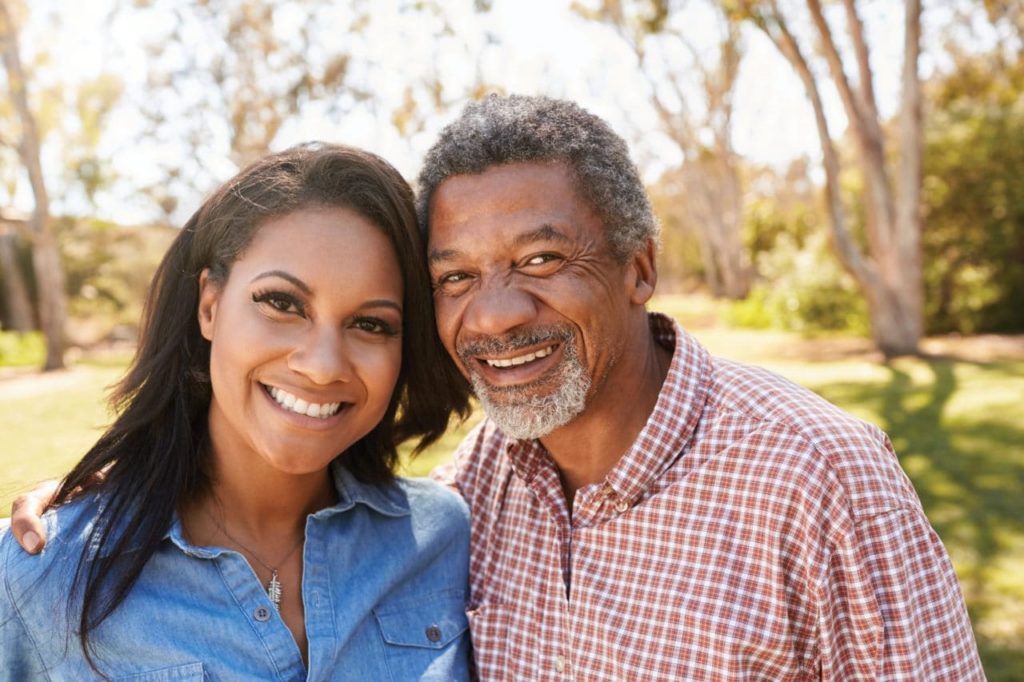 A father and daughter are in a happy mood.