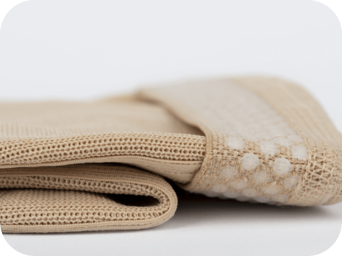 close-up view of a folded beige compression stocking