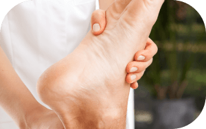 Close-up of a hand massaging a foot and ankle.