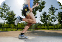 a close-up view of a runner's legs and feet in motion