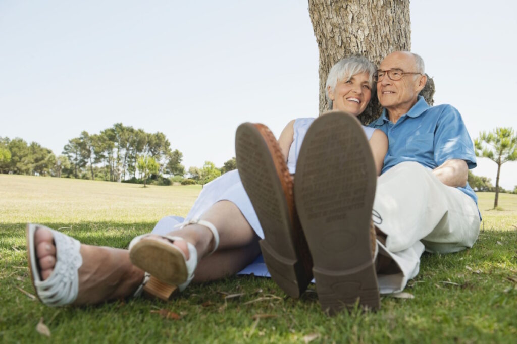 wound care senior couple sitting by tree