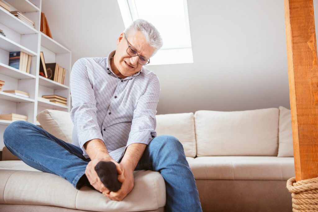 chronic foot senior man suffering with foot pain