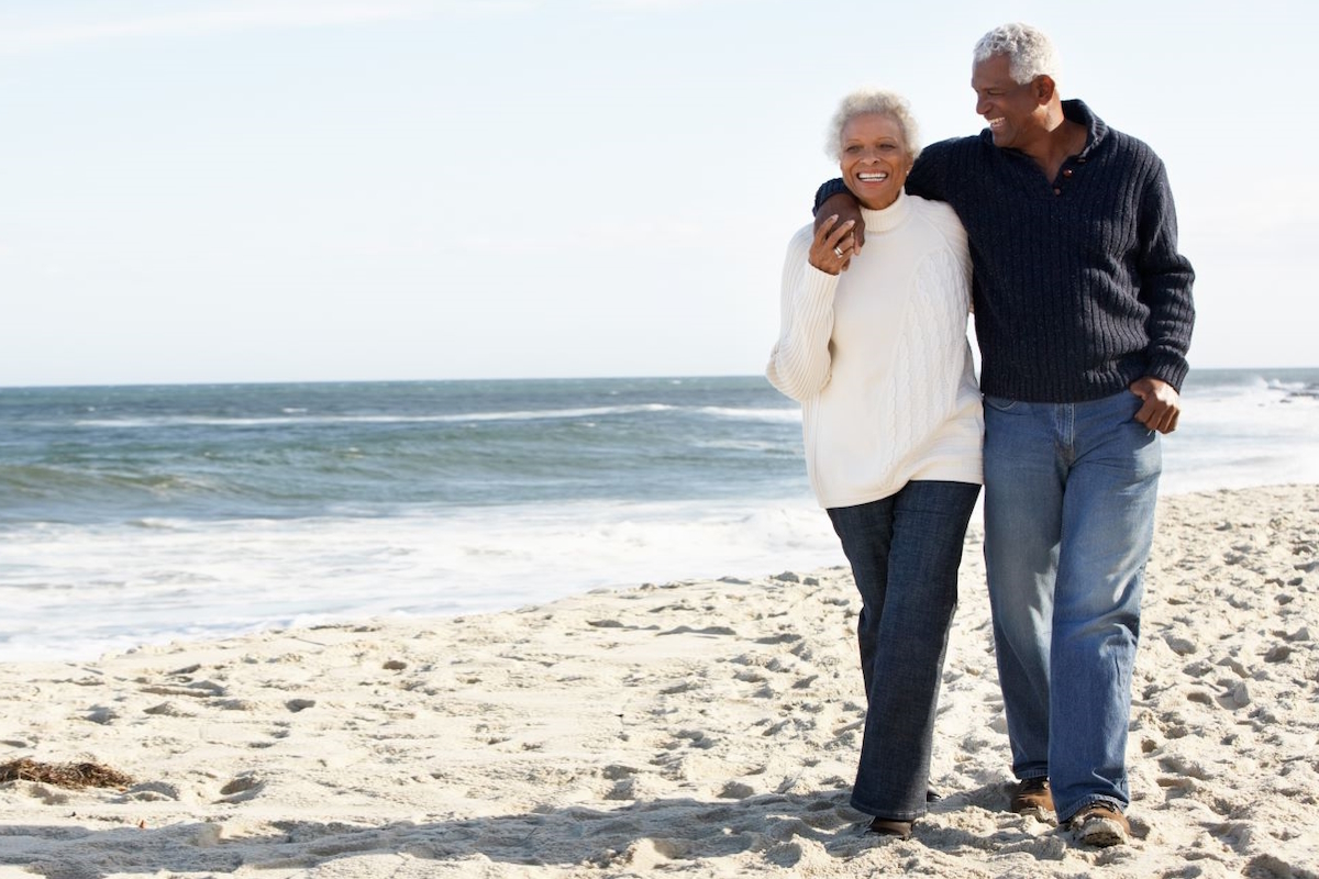 foot pain couple walking along beach